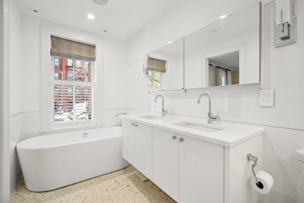 211 West Canton Street, Unit 1 Boston, MA 02116 - Photo 10 of 33 a bathroom with a tub sink and mirror
