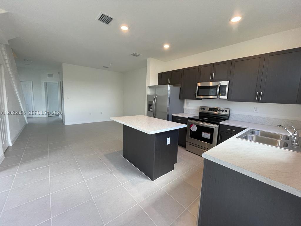 10144 Southwest 228th Terrace Miami, FL 33190 - Photo 8 of 23 a kitchen with a cabinets and a counter top space