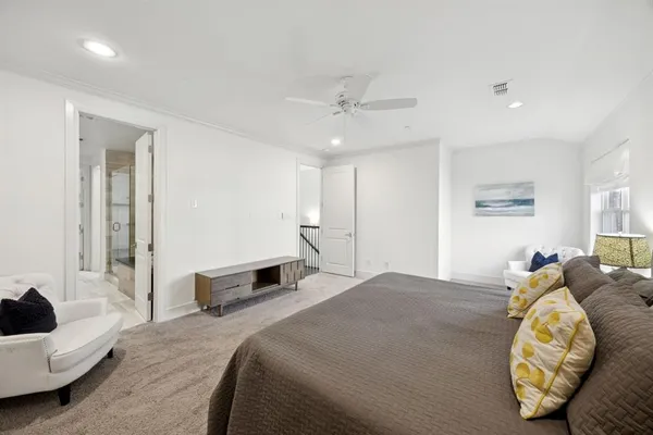 a bedroom with a bed and a chair
