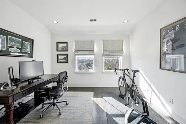 a view of a workspace with furniture and a window