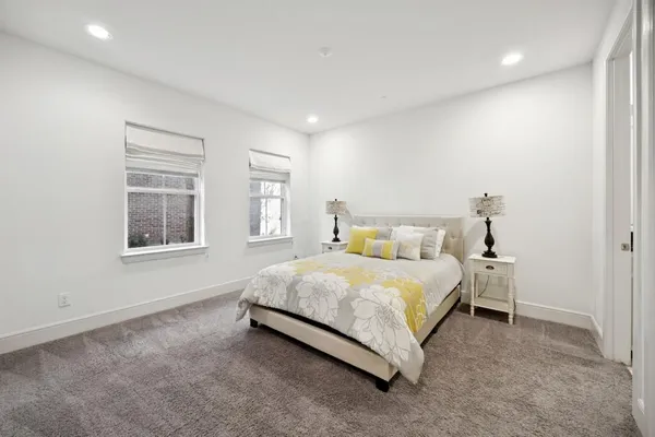 a spacious bedroom with a bed and a window