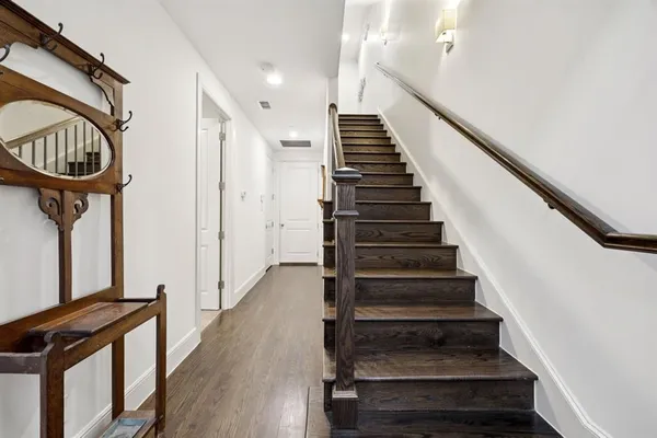a view of entryway and hall with wooden floor