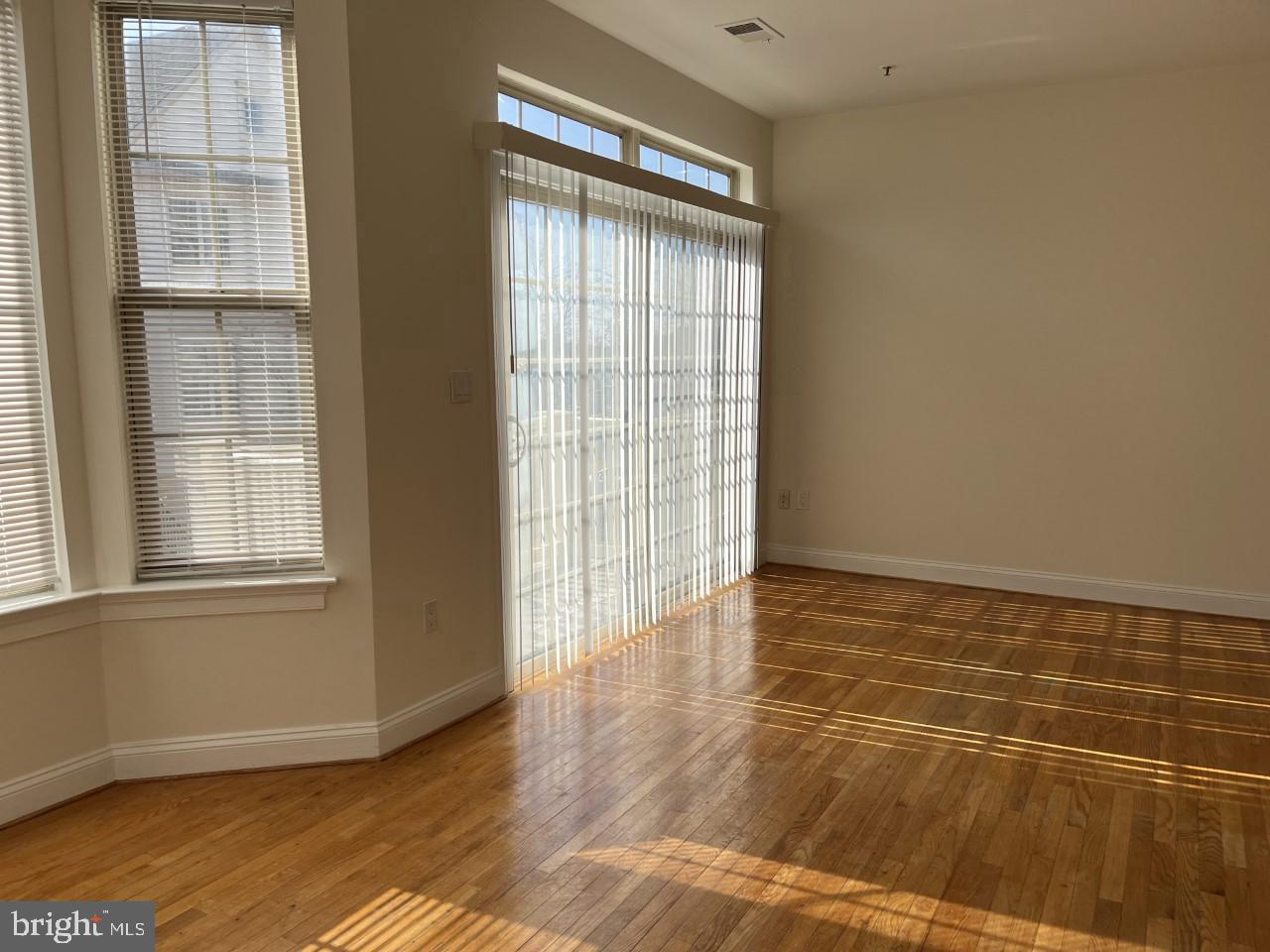 46378 Monocacy Square, Unit 86 Sterling, VA 20165 - Photo 14 of 22 a view of an empty room with wooden floor and a window