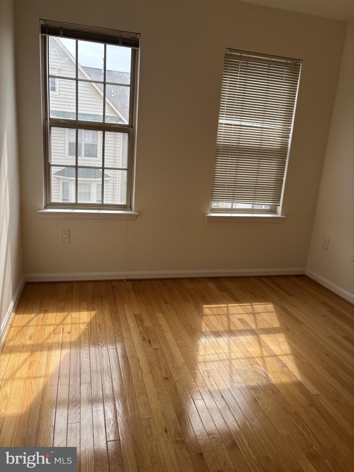46378 Monocacy Square, Unit 86 Sterling, VA 20165 - Photo 21 of 22 an empty room with wooden floor and windows