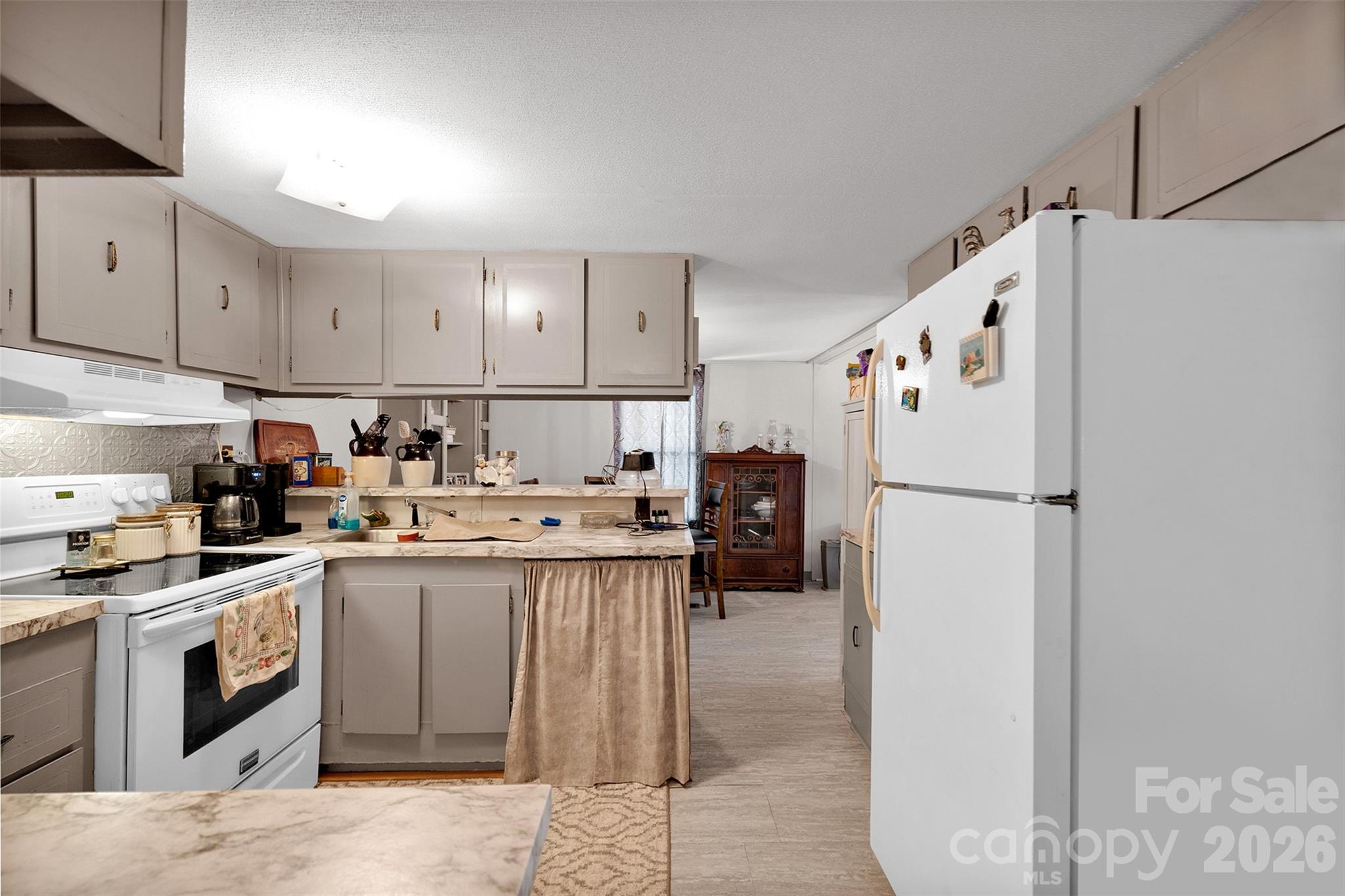 2187 McBee Highway Bethune, SC 29009 - Photo 12 of 38 a kitchen with a refrigerator a stove top oven a sink and cabinets