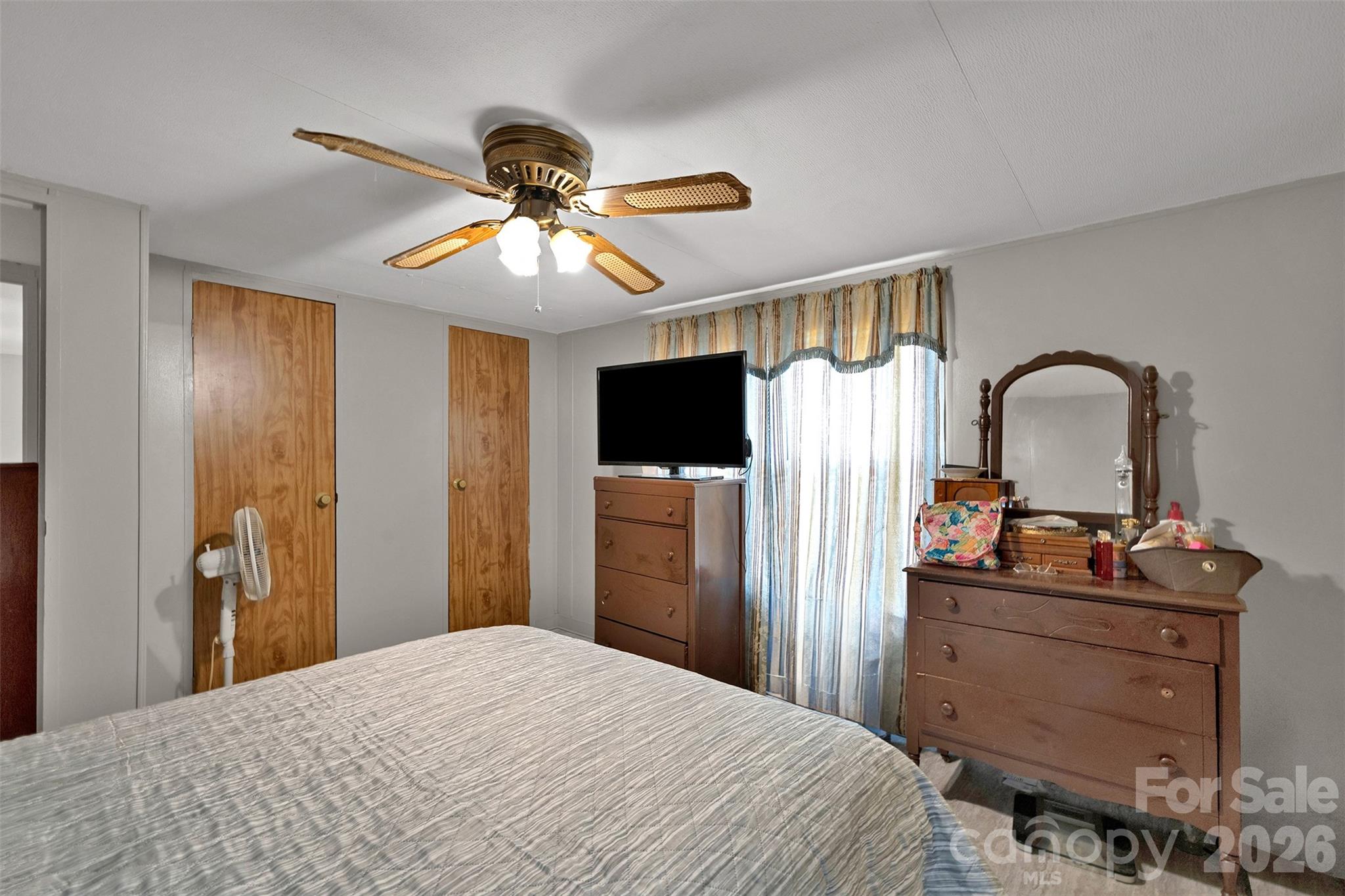 2187 McBee Highway Bethune, SC 29009 - Photo 16 of 38 a bedroom with a bed and a chandelier