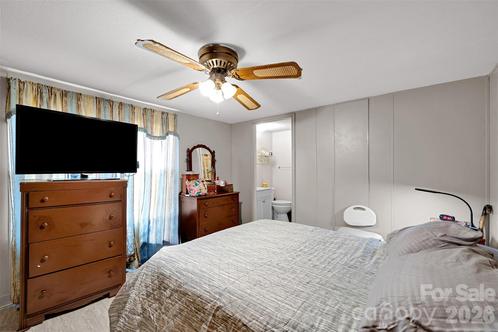 2187 McBee Highway Bethune, SC 29009 - Photo 17 of 38 a bedroom with a bed and a flat tv screen on dresser