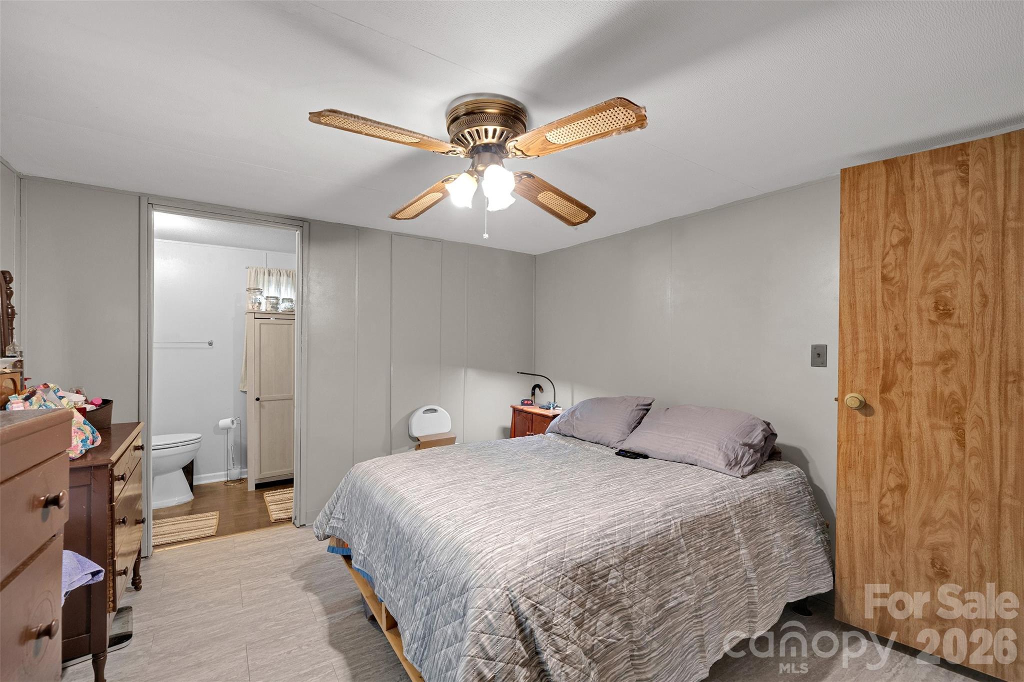 2187 McBee Highway Bethune, SC 29009 - Photo 18 of 38 a bedroom with a bed and a chandelier
