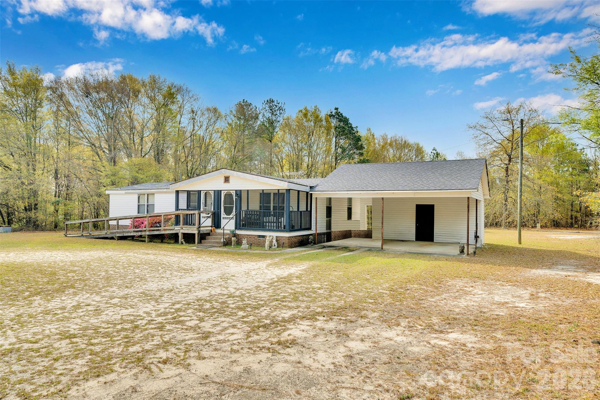 2187 McBee Highway Bethune, SC 29009 - Photo 2 of 38 a swimming pool with some trees in the background