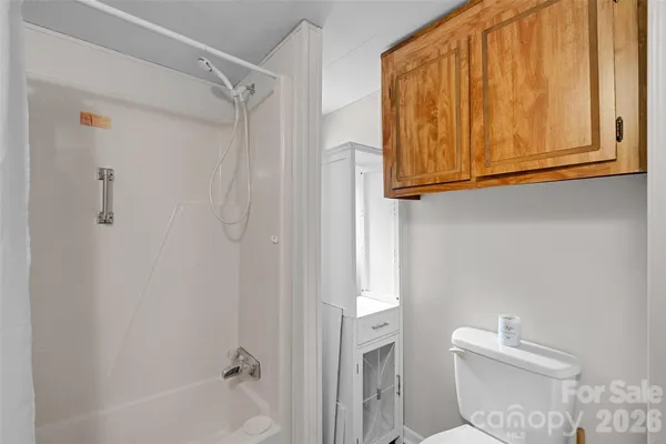 a bathroom with a shower a toilet and a sink