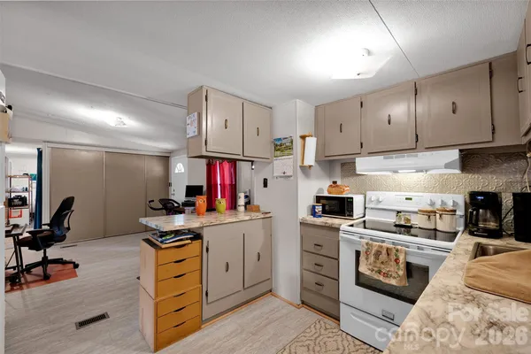 a kitchen with a sink stove and white cabinets