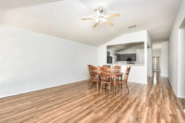 a view of a dining room with furniture and wooden floor