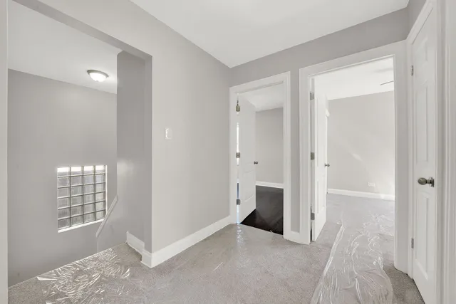a view of an empty room with windows and wardrobe
