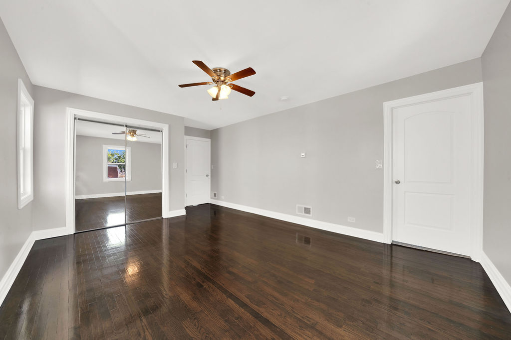 8033 South Campbell Avenue Chicago, IL 60652 - Photo 20 of 30 a view of empty room with wooden floor and ceiling fan