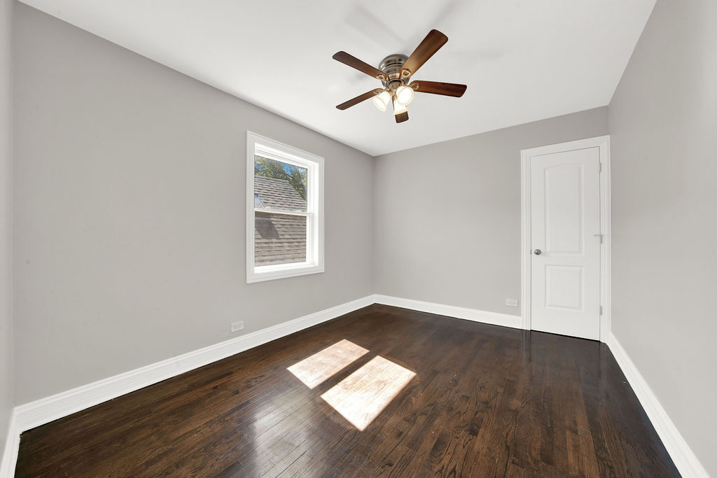 8033 South Campbell Avenue Chicago, IL 60652 - Photo 21 of 30 an empty room with wooden floor and windows