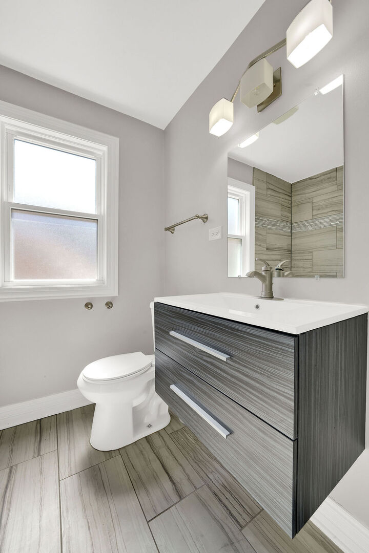 8033 South Campbell Avenue Chicago, IL 60652 - Photo 23 of 30 a bathroom with a sink toilet a mirror and window
