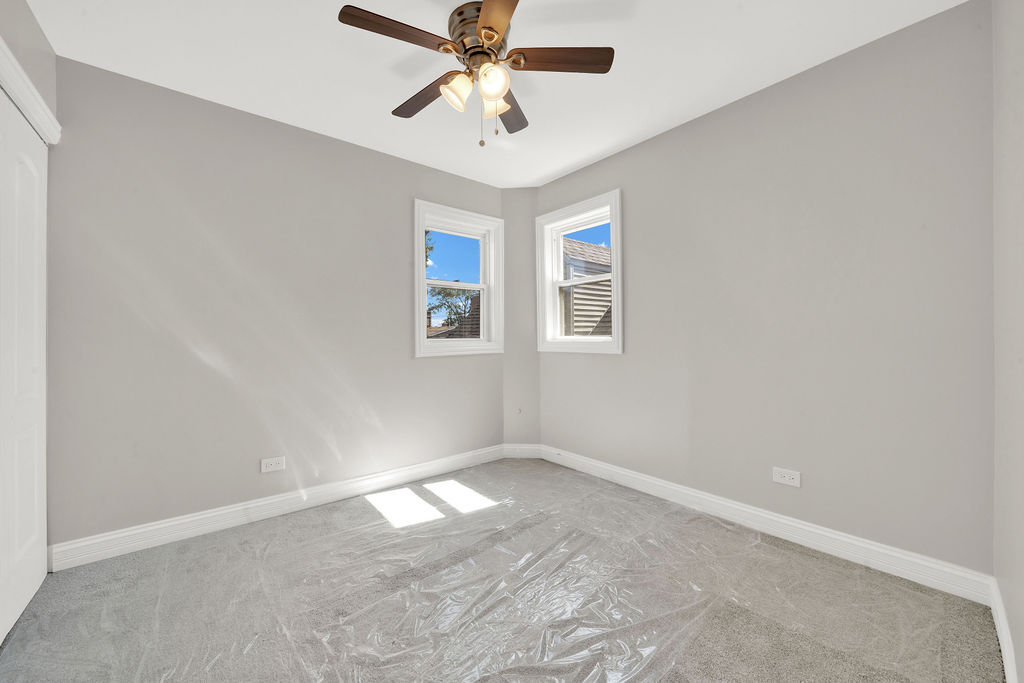 8033 South Campbell Avenue Chicago, IL 60652 - Photo 25 of 30 an empty room with windows and fan