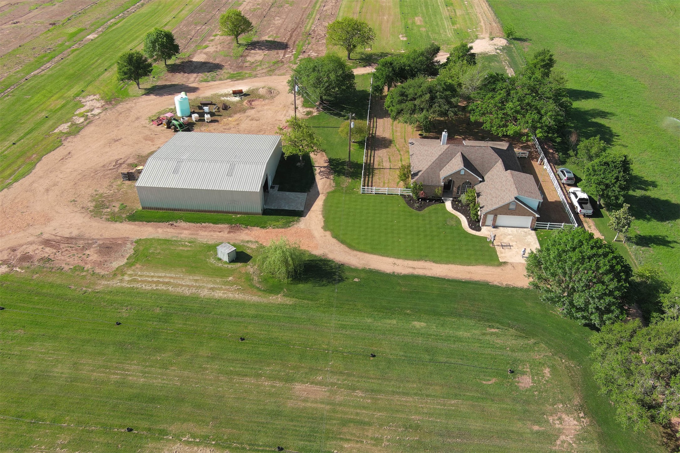 678 Ponderosa Road Bastrop, TX 78602 - Photo 1 of 40 Drone / aerial view featuring house and barn.