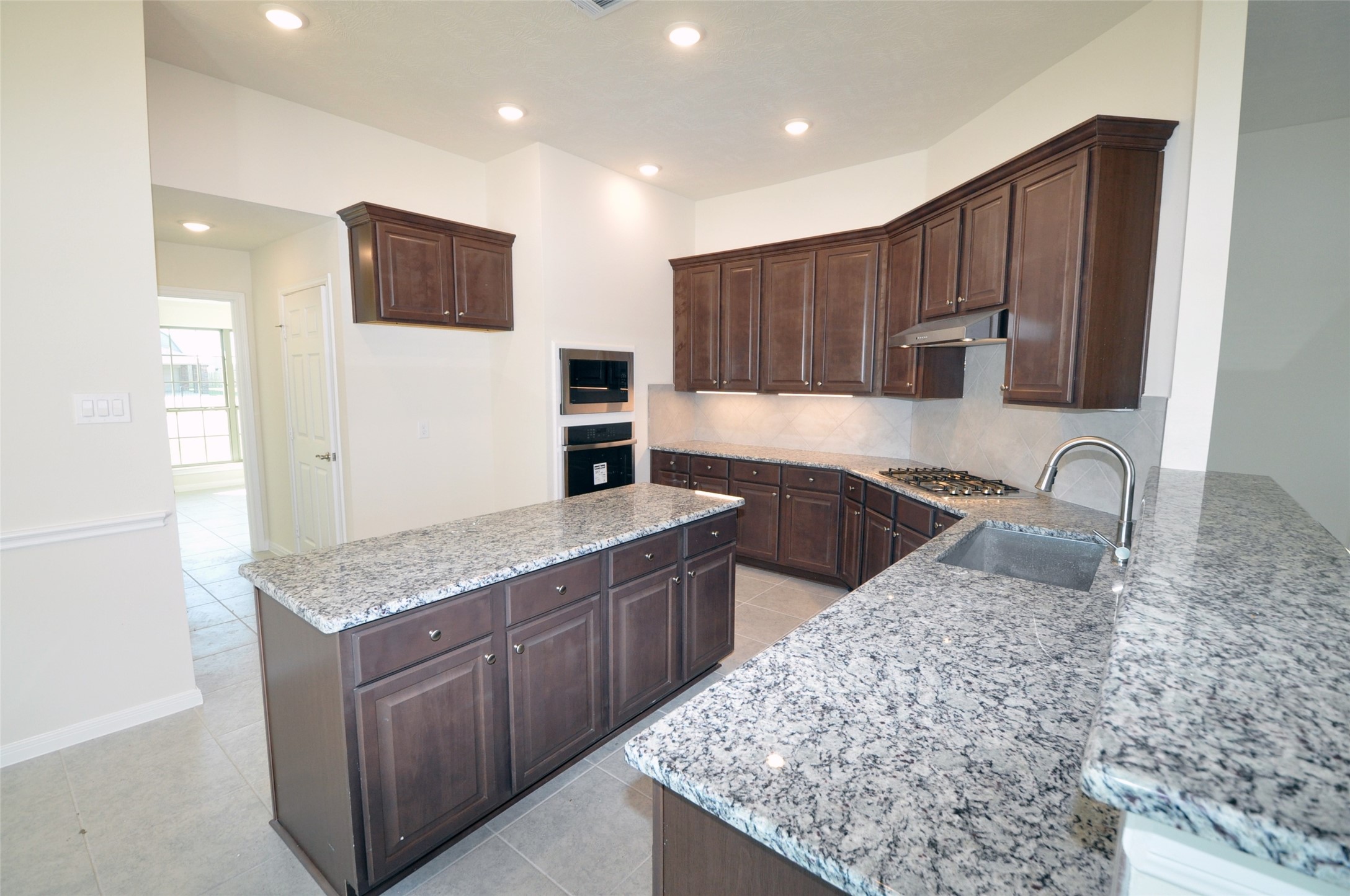 3705 Pedregal Road League City, TX 77573 - Photo 12 of 50 a kitchen with stainless steel appliances granite countertop a sink stove and refrigerator