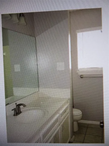 a bathroom with a shower toilet and sink