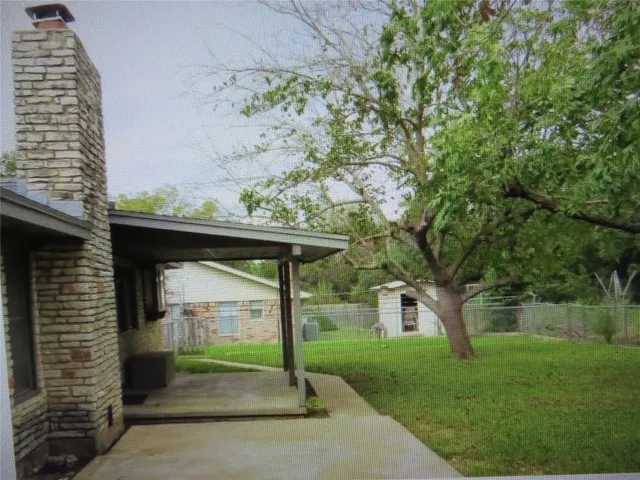 a view of a small garden area with large trees