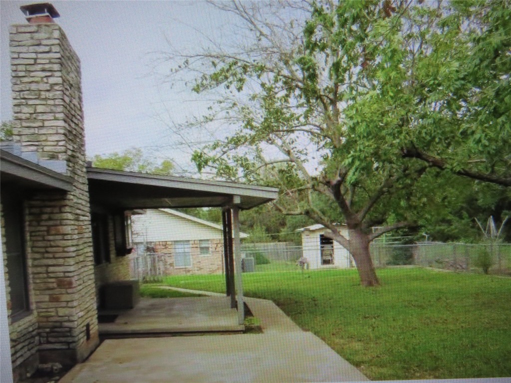 404 San Gabriel Boulevard Georgetown, TX 78628 - Photo 13 of 13 a view of a small garden area with large trees