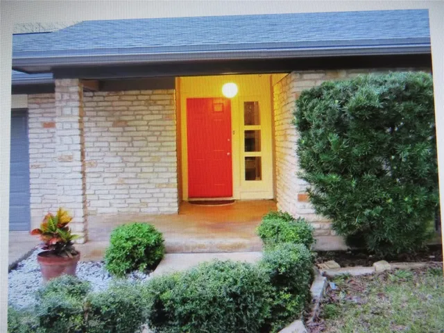 a front view of a house with a yard and fountain