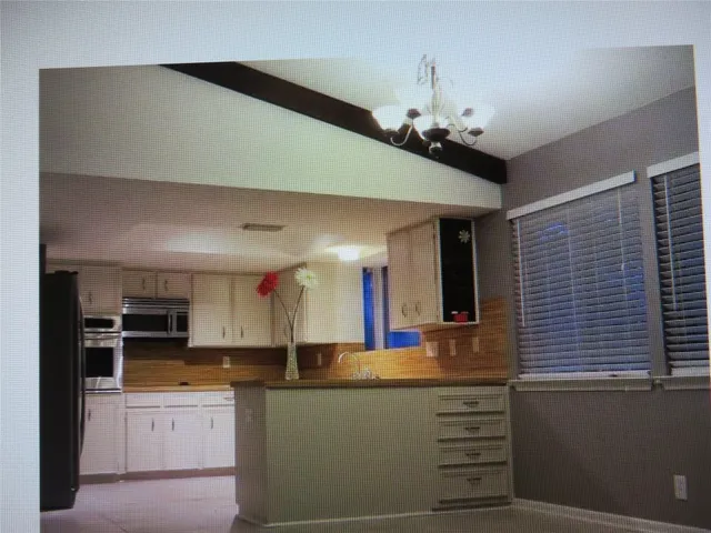 a kitchen with kitchen island granite countertop a stove and a sink