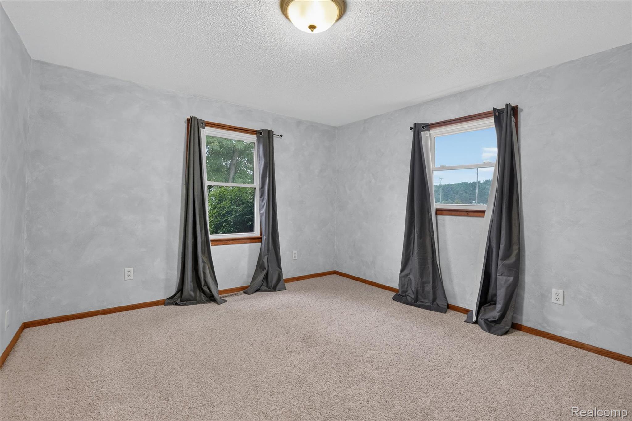 10977 Maple Road Birch Run, MI 48415 - Photo 26 of 49 Wall-to-wall carpeting, dual windows with wood trim, and a ceiling-mounted light fixture