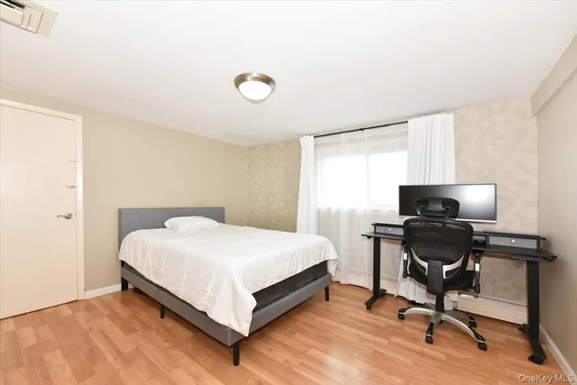 a bedroom with a bed and a desk