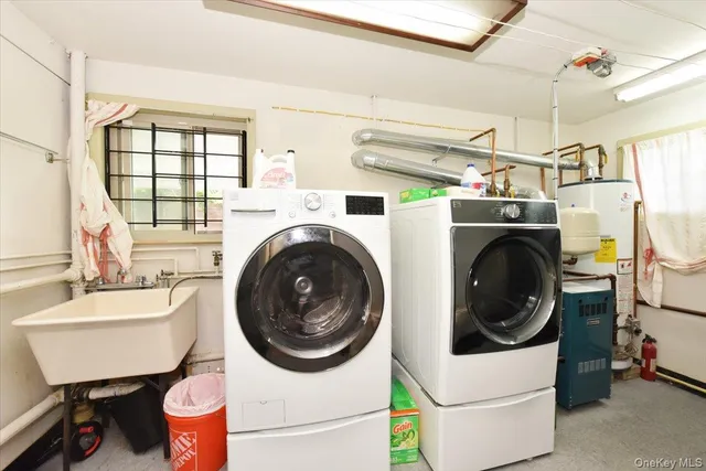 a utility room with sink dryer and washer