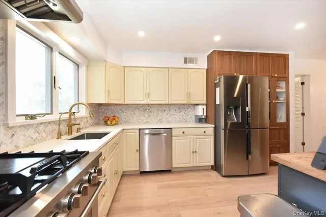 a kitchen with a refrigerator stove and sink