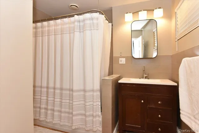 a bathroom with a double vanity sink and a mirror