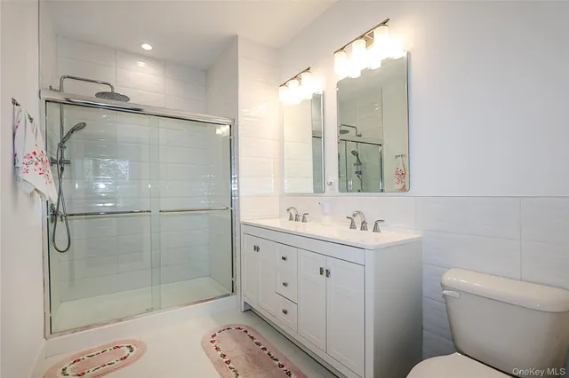 a bathroom with a toilet sink and shower