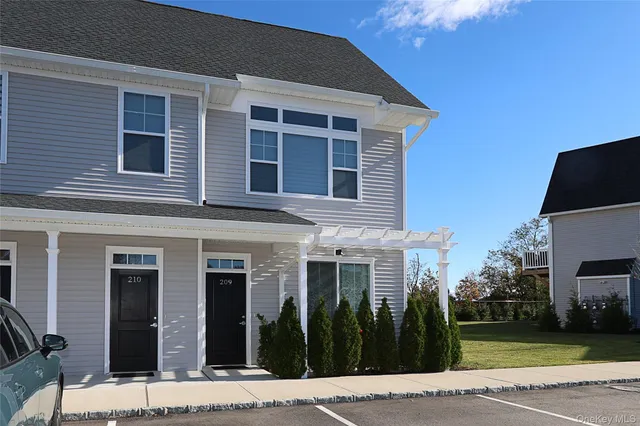 a view of a brick house with many windows