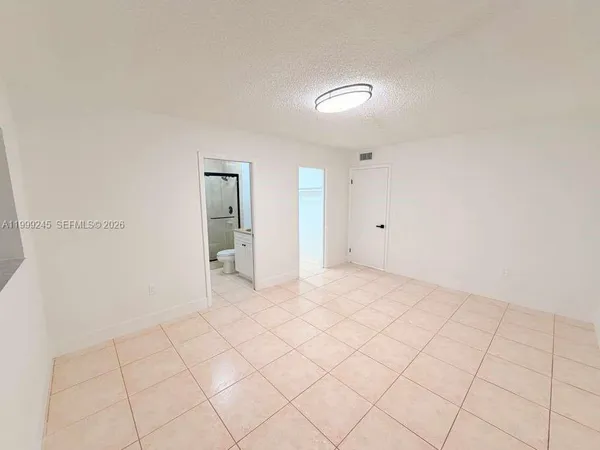a view of an empty room with windows