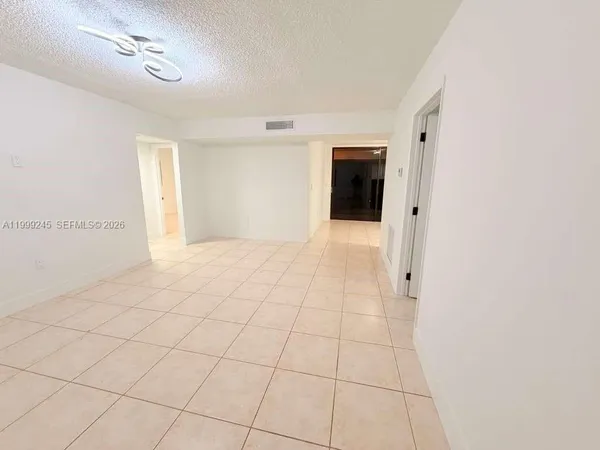 a kitchen with stainless steel appliances kitchen island granite countertop a refrigerator and a stove top oven