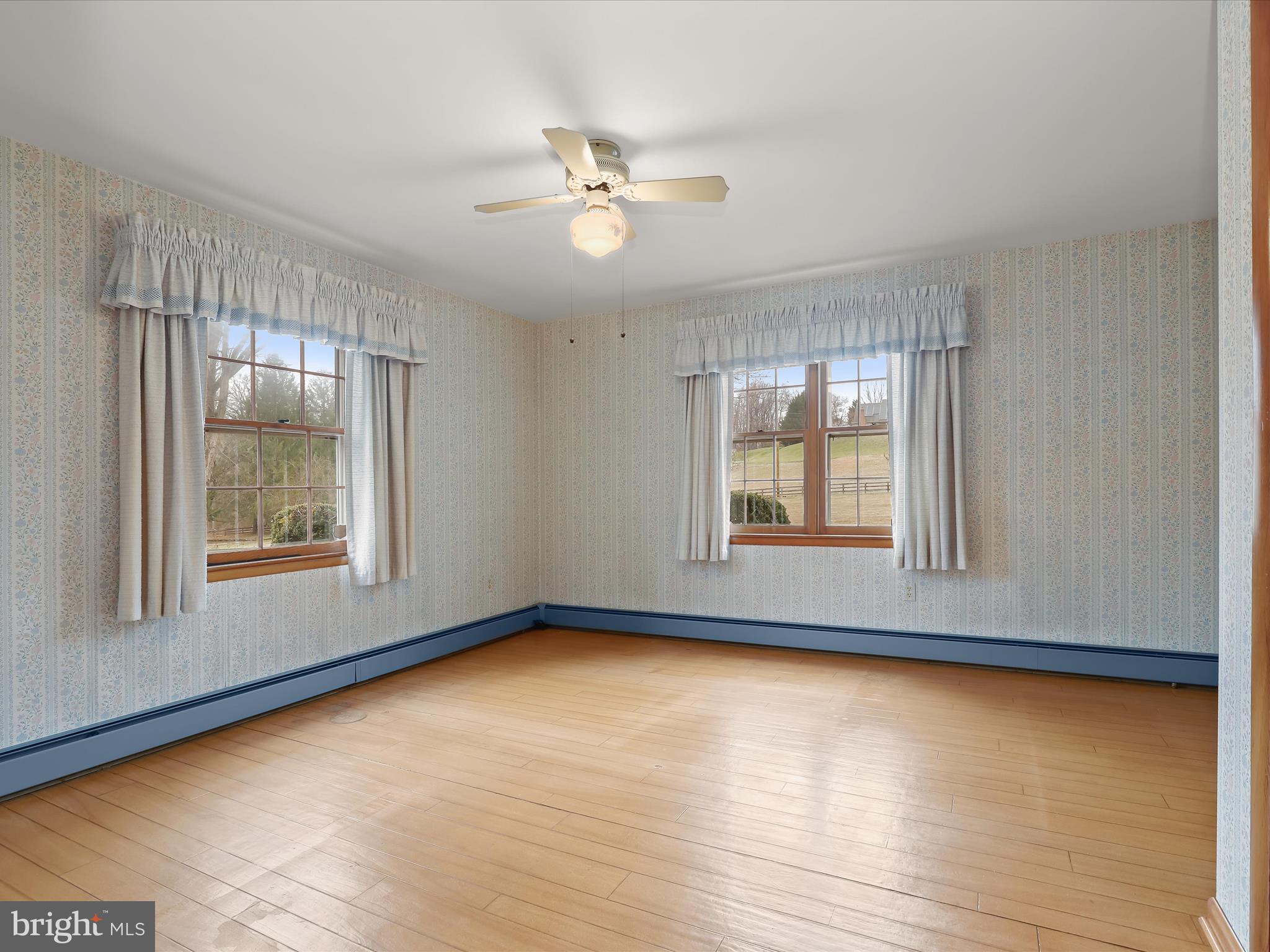 16215 Dark Hollow Road Upperco, MD 21155 - Photo 12 of 33 a view of an empty room with wooden floor and a window