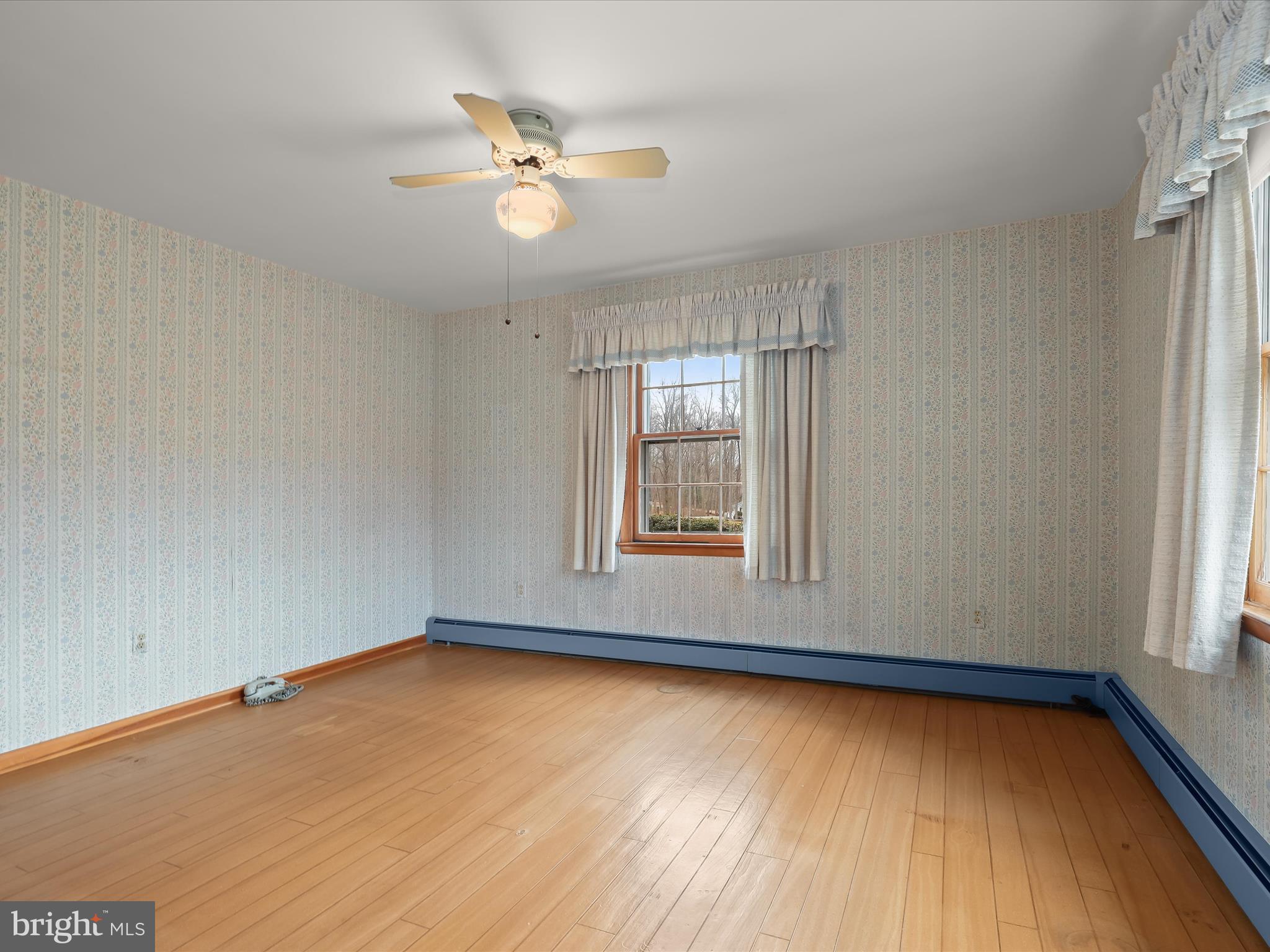 16215 Dark Hollow Road Upperco, MD 21155 - Photo 13 of 33 an empty room with wooden floor and windows