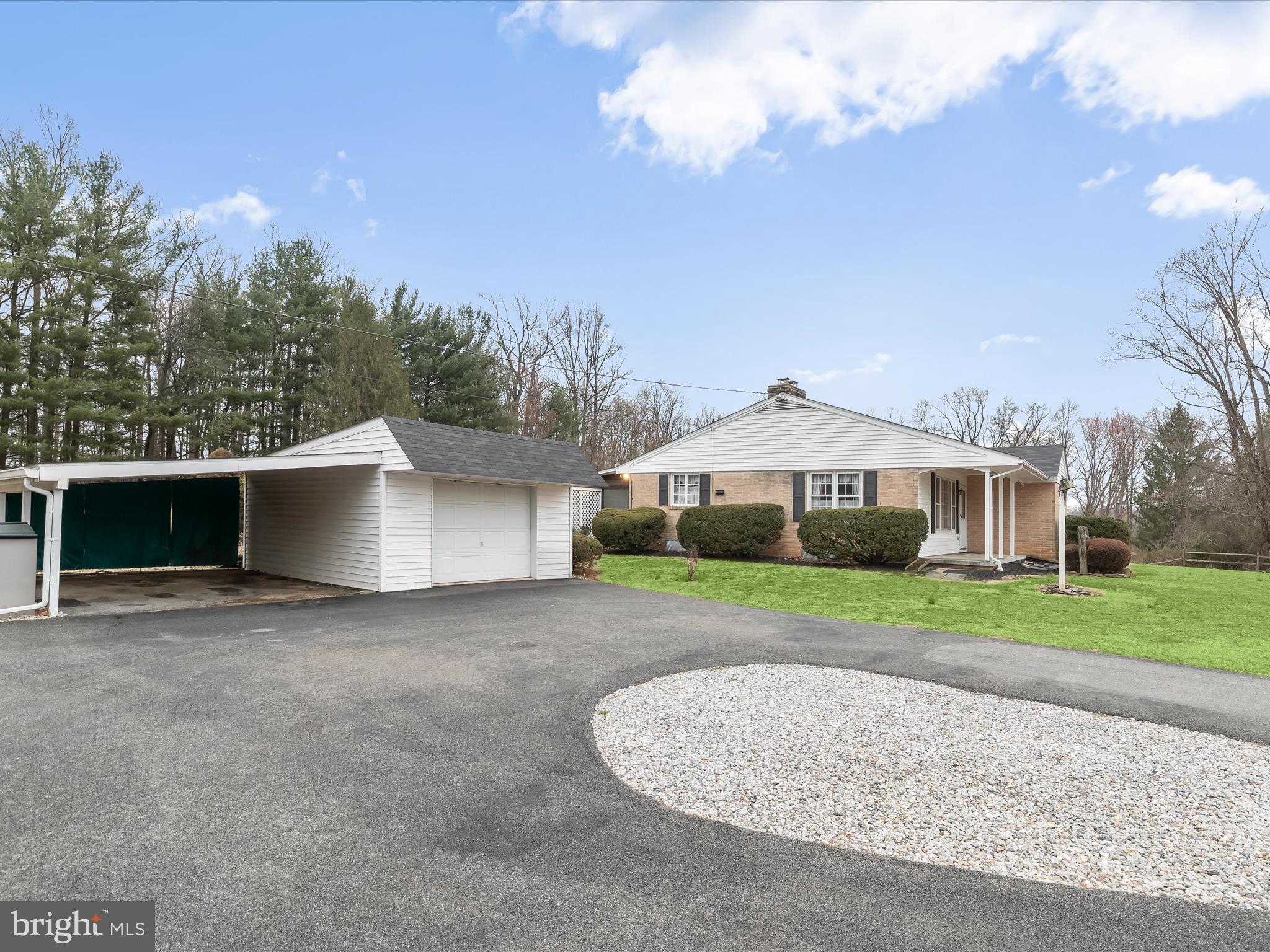 16215 Dark Hollow Road Upperco, MD 21155 - Photo 25 of 33 a front view of a house with a yard and garage