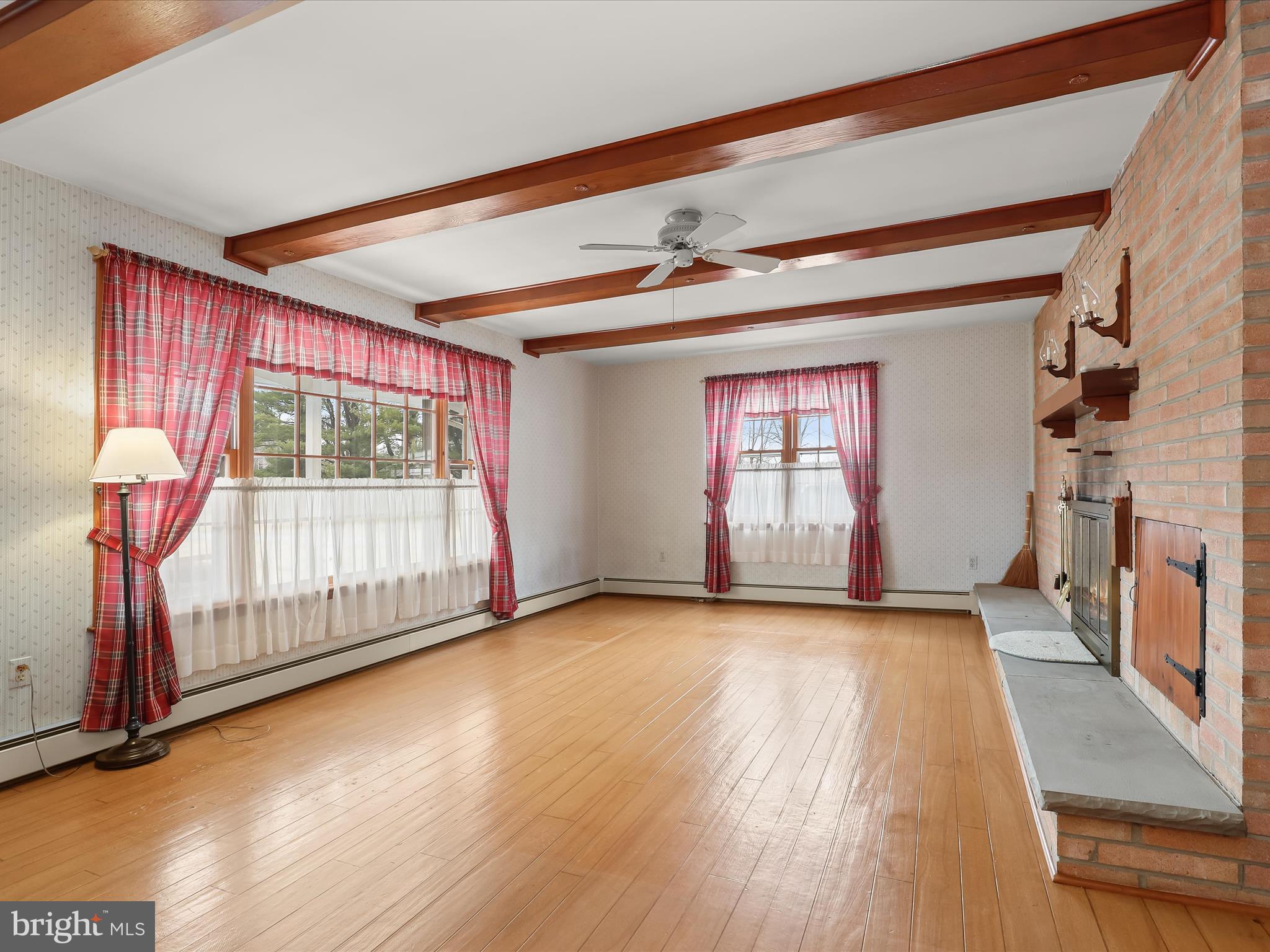 16215 Dark Hollow Road Upperco, MD 21155 - Photo 3 of 33 a view of empty room with wooden floor and fan