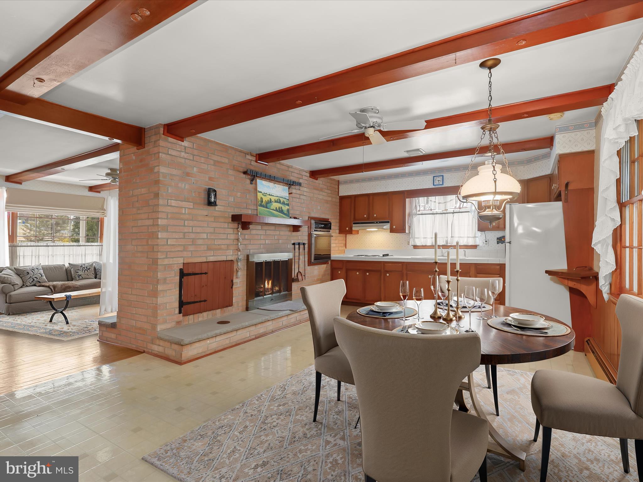 16215 Dark Hollow Road Upperco, MD 21155 - Photo 6 of 33 a dining room with furniture a fireplace and wooden floor
