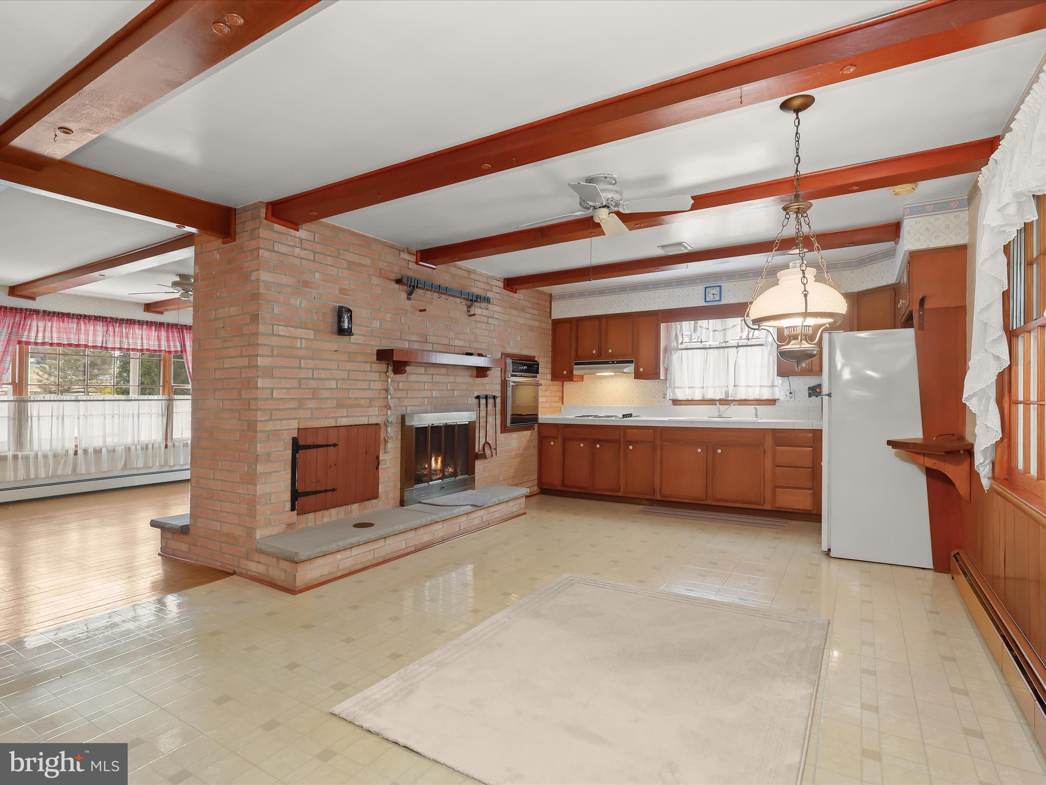 16215 Dark Hollow Road Upperco, MD 21155 - Photo 7 of 33 a view of a livingroom with a fireplace a chandelier and windows
