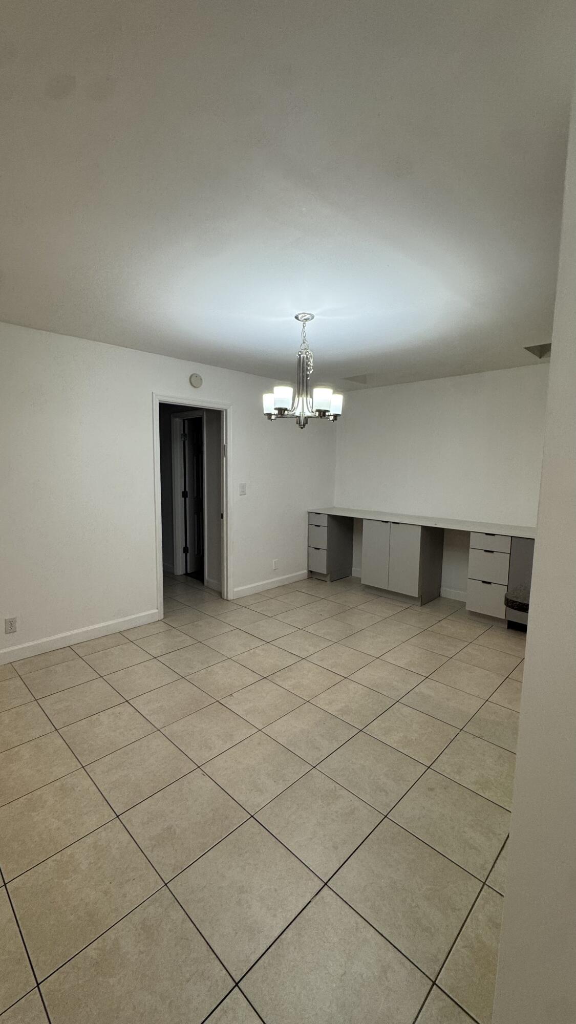 802 St Andrews Road, Unit 15 Hollywood, FL 33021 - Photo 16 of 53 an empty room with a cabinet and mirrors