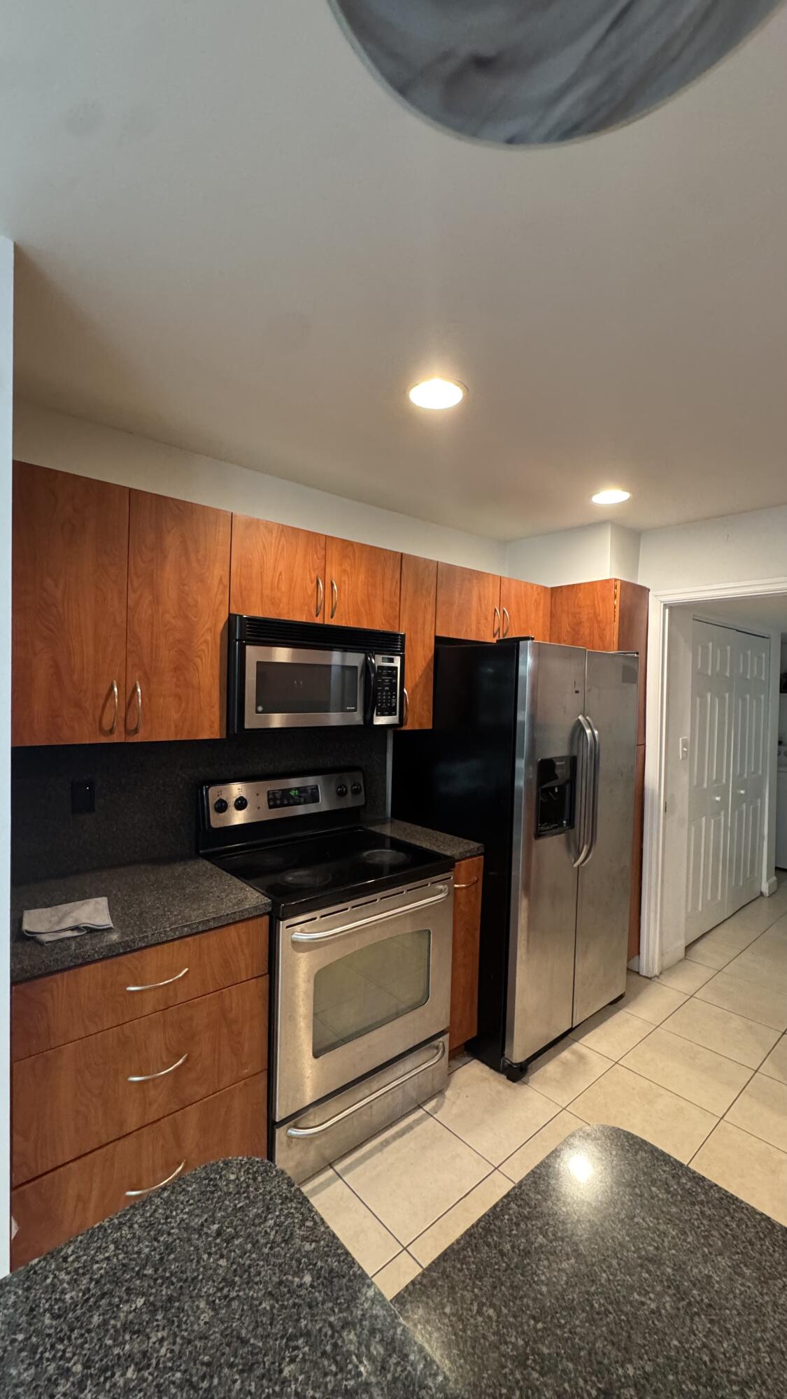802 St Andrews Road, Unit 15 Hollywood, FL 33021 - Photo 19 of 53 a kitchen with stainless steel appliances kitchen island granite countertop a stove and a sink