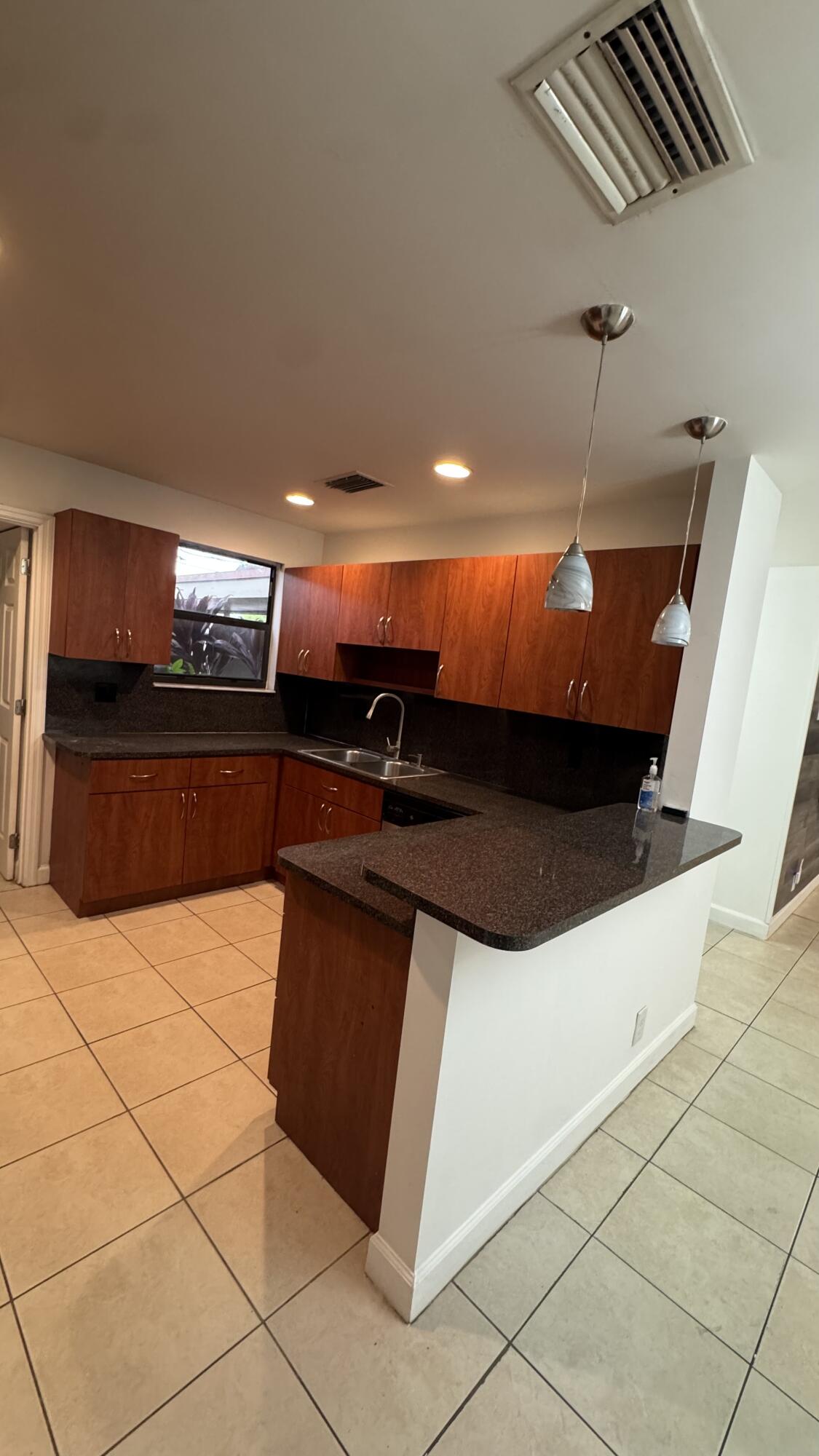 802 St Andrews Road, Unit 15 Hollywood, FL 33021 - Photo 20 of 53 a kitchen with stainless steel appliances kitchen island a sink and cabinets