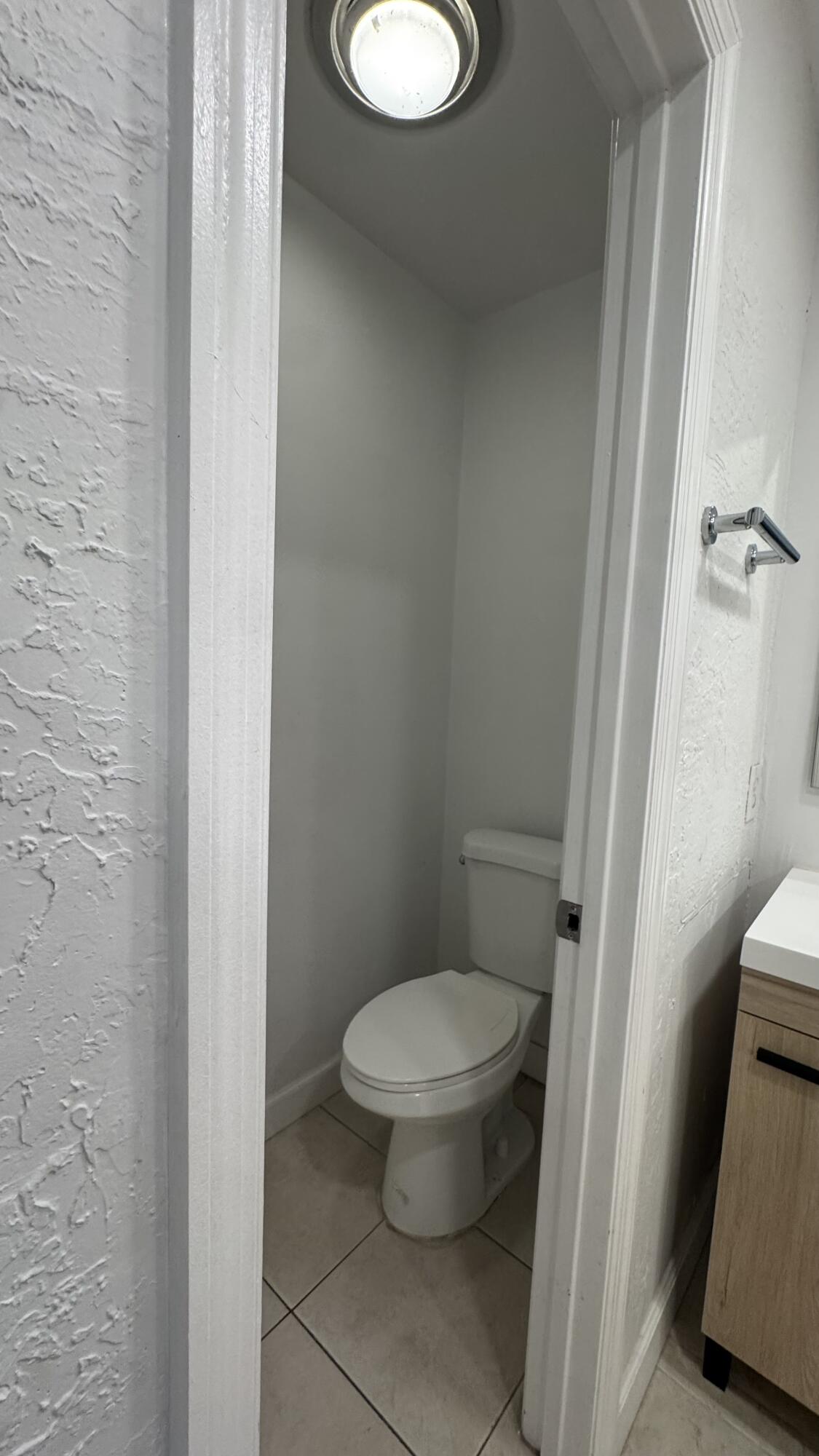 802 St Andrews Road, Unit 15 Hollywood, FL 33021 - Photo 34 of 53 a white toilet sitting next to a small sink