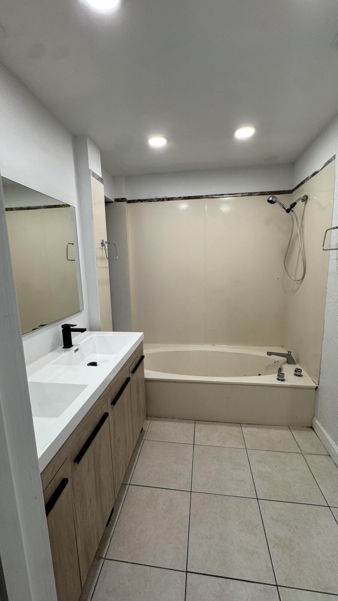 802 St Andrews Road, Unit 15 Hollywood, FL 33021 - Photo 36 of 53 a bathroom with a sink a toilet and a mirror