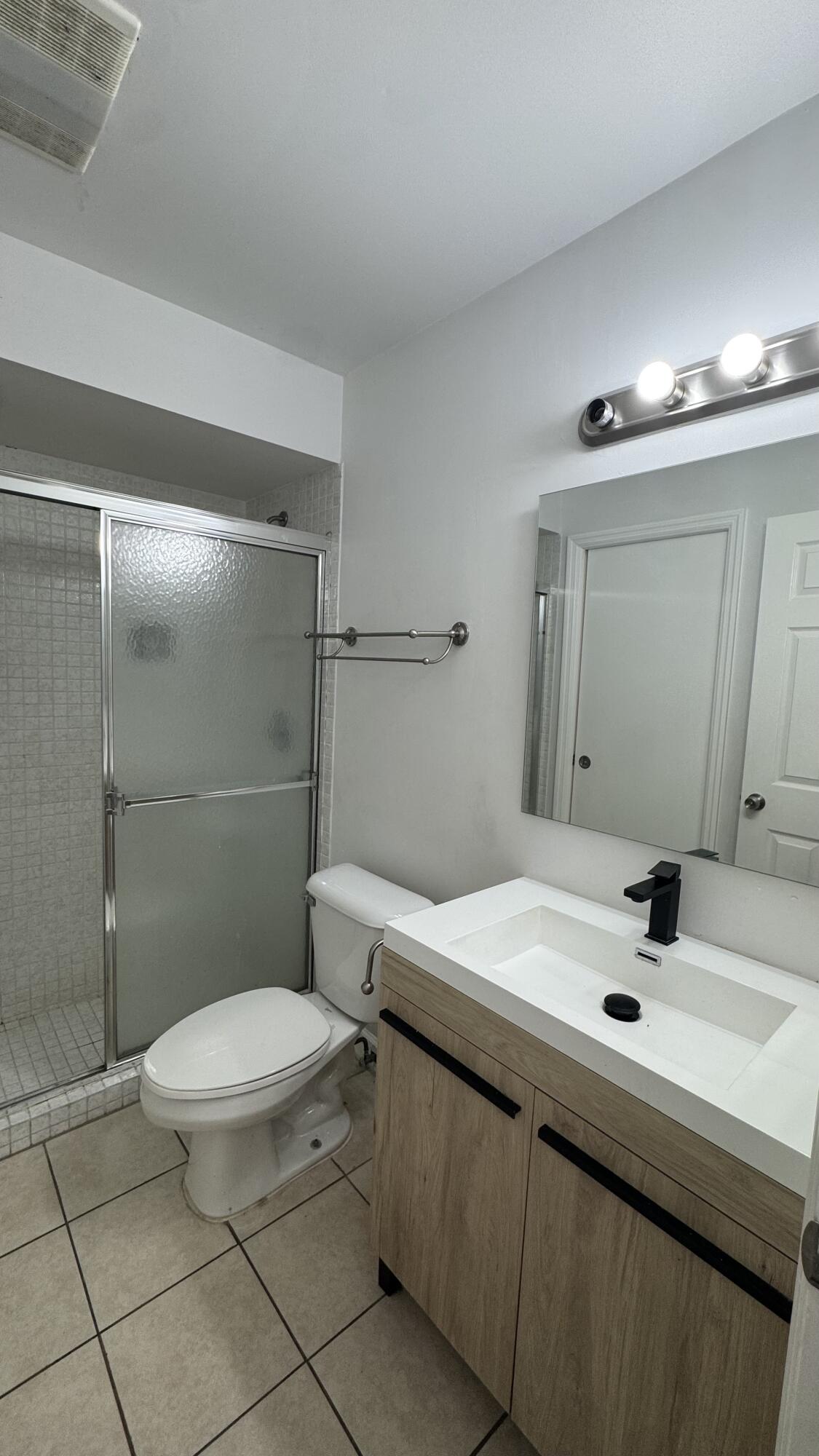 802 St Andrews Road, Unit 15 Hollywood, FL 33021 - Photo 10 of 53 a bathroom with a sink a toilet and a mirror