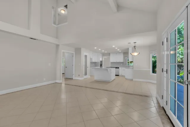a view of a livingroom with kitchen and furniture